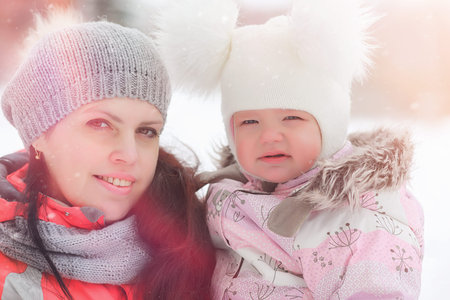 Children walk in the park in winter. Winter forest a family with