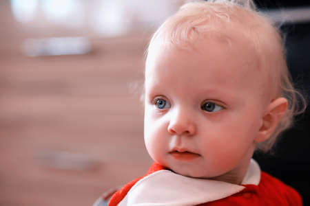 Portrait of a young blond child with blue eyesの写真素材