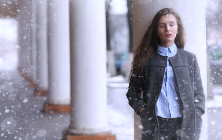 Young girl outdoors in winter. Model girl posing outdoors on a wの写真素材