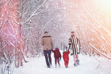 Young family with children are walking in the winter park. Winteの写真素材