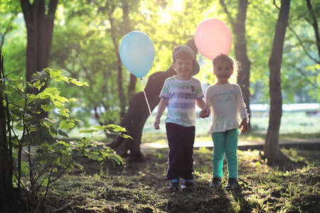 Little children are walking in a parkの写真素材