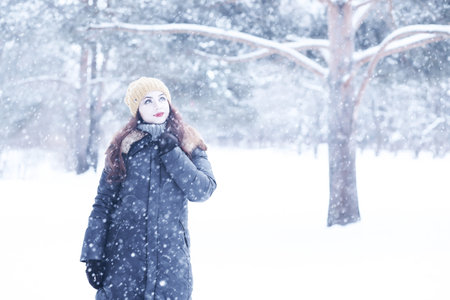 Beautiful girl in a beautiful winter snowの写真素材