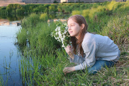 A girl on a walk in an autumn park. Young red-haired girl in theの写真素材
