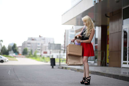 Beautiful young blonde with little dogの写真素材