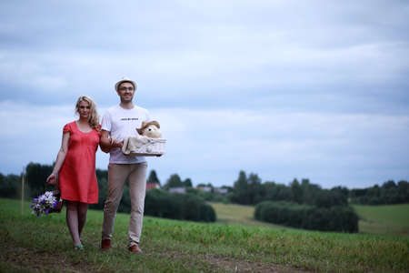 Pregnant girl with big belly and young man outdoorの写真素材