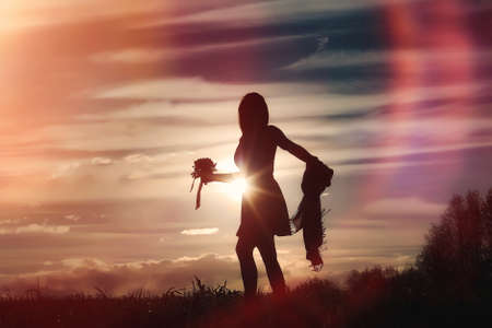 A girl in a hat on a walk in the park. A girl with a basket walkの写真素材