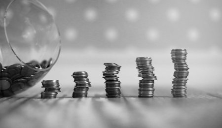 Coins in a jar on the floor. Accumulated coins on the floor