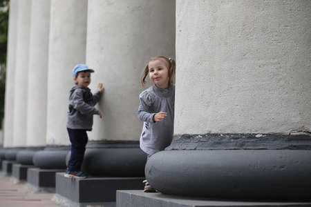 Children on a walk in the spring in the city park. The girl is wの写真素材