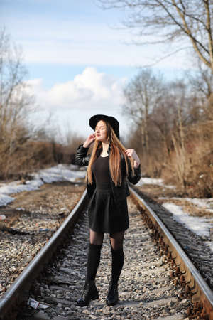 Young beautiful girl in a hat and with a dark make-up outside. Gの写真素材
