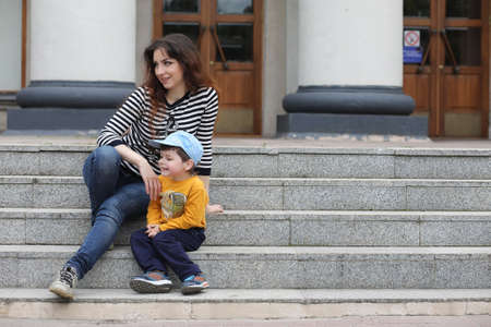 Children on a walk in the spring in the city park. The girl is wの写真素材