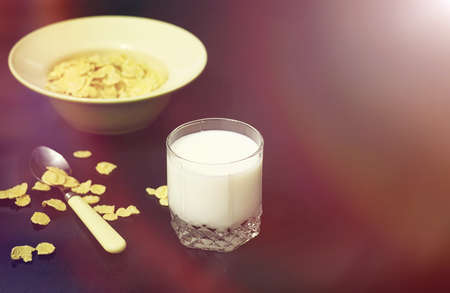 Corn flakes in a plate. Breakfast from flakes with honey and milkの写真素材