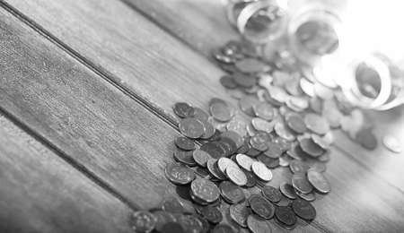 Coins in a jar on the floor. Accumulated coins on the floor. Pocket savings in piles.
の写真素材