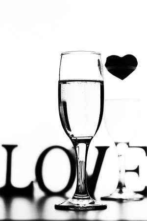 glass of champagne on white table on a white background isolateの写真素材