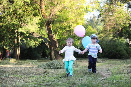 Little children are walking in a parkの写真素材