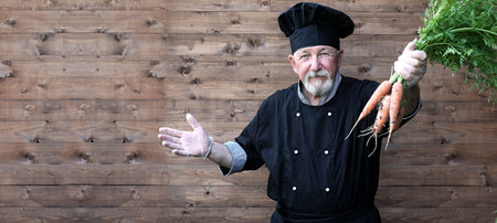 Chef old in uniform with vegetablesの写真素材