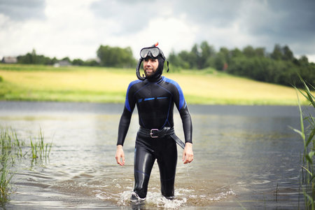 A scuba diver in a wet suit preparesの写真素材