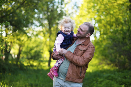 Girl with father in the park in the spring