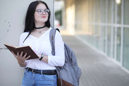 Girl student on the street with booksの写真素材