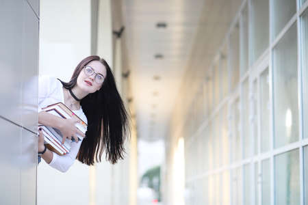 Girl student on the street with booksの写真素材