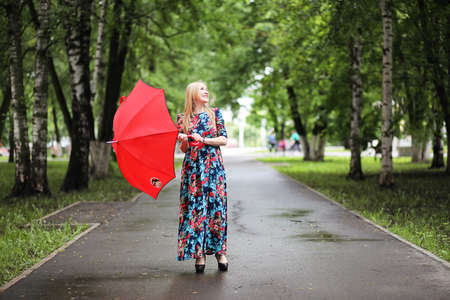 Girl in the street with an umbrellaの写真素材