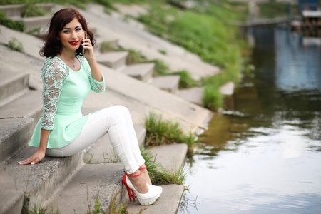 Beautiful girl in a spring leaf parkの写真素材