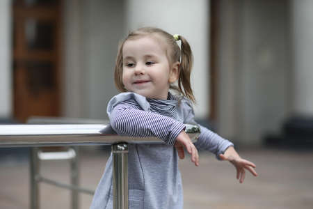 Children on a walk in the spring in the city park. The girl is wの写真素材