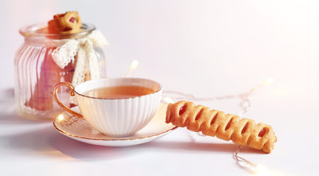 Tea with pastries for breakfast. Sweets and pastries with nuts for tea on white background. A coffee...
