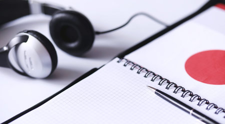 Learning foreign languages. Notepad for entries and a flag. Language courses, audio audition