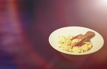 Corn flakes in a plate. Breakfast from flakes with honey and milk. Fast breakfast with corn flakes