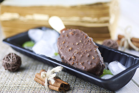 Dessert chocolate ice cream with nuts on a wooden stickの写真素材