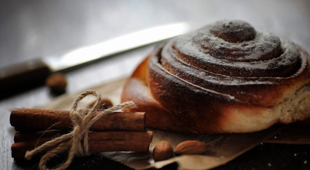 Pie with cinnamon and apples on a wooden table. Fresh pastry witの写真素材