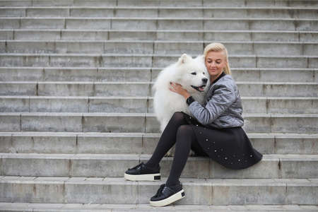 Lovely girl on a walk with a beautiful dogの写真素材