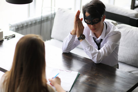 A pair of young people talking at the office