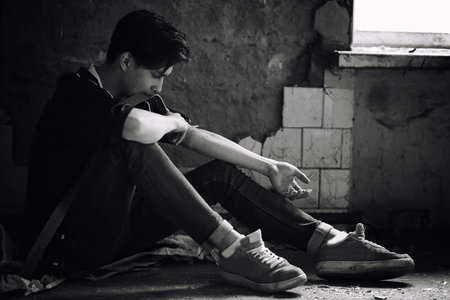 A young man takes drugsの写真素材