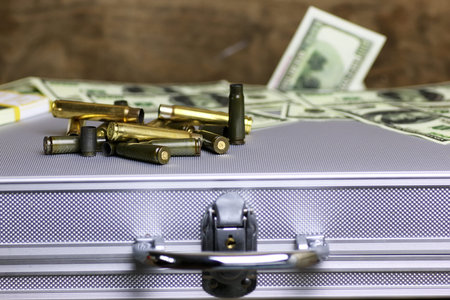 bullet and money dollar on the silver caseの写真素材
