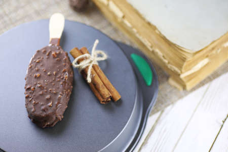 Dessert chocolate ice cream with nuts on wooden stickの写真素材