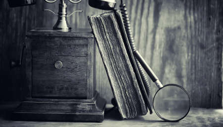 Old telephone and retro book on the desk. The phone of the pastの写真素材