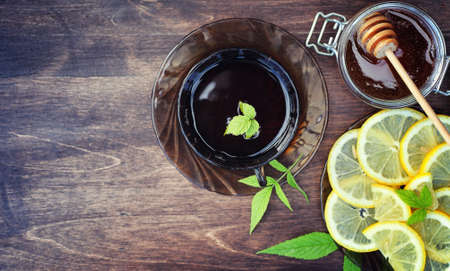Tea with lemon and mint in nature. A cup of hot mint tea with leの写真素材