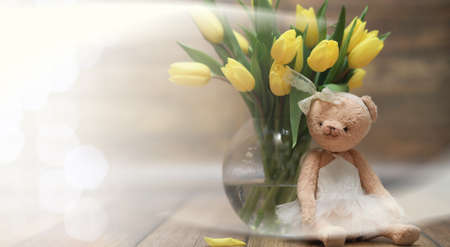 bouquet of yellow tulips in a vase on the floorの写真素材