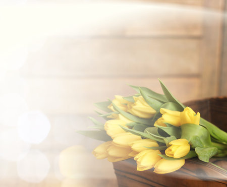 bouquet of yellow tulips in a vase on the floorの写真素材