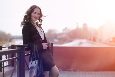 Girl business woman in the spring on a walk in a coatの写真素材