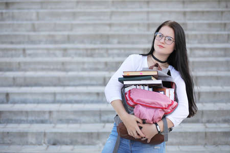 Girl student on the street with booksの写真素材