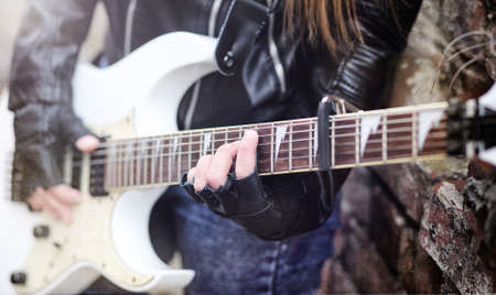 Beautiful young girl rocker with electric guitar. A rock musiciaの写真素材