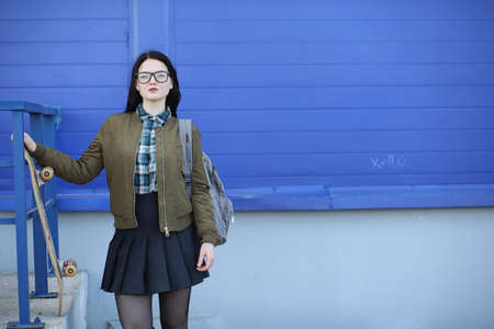A young hipster girl is riding a skateboard. Girls girlfriends fの写真素材