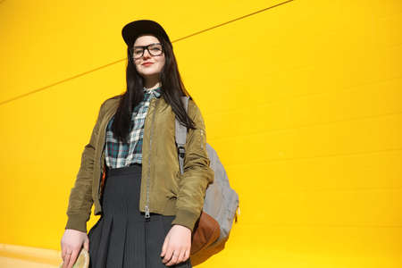 A young hipster girl is riding a skateboard. Girls girlfriends fの写真素材