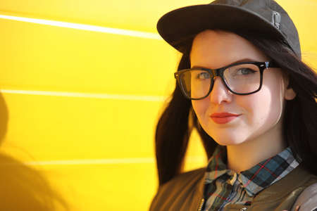 A young hipster girl is riding a skateboard. Girls girlfriends fの写真素材