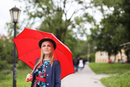 Girl in the street with an umbrellaの写真素材