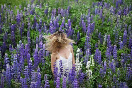 Girl with a bouquet of blue flowersの写真素材