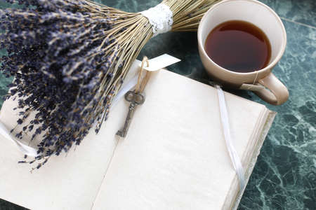 Vintage notebook on green marble windowsill opened with blank paの写真素材