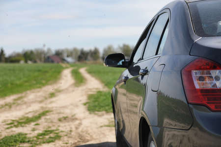 The car is parked in the field. The car is driving along the rurの写真素材